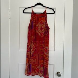 Adorable halter top mini red dress with patchwork print.